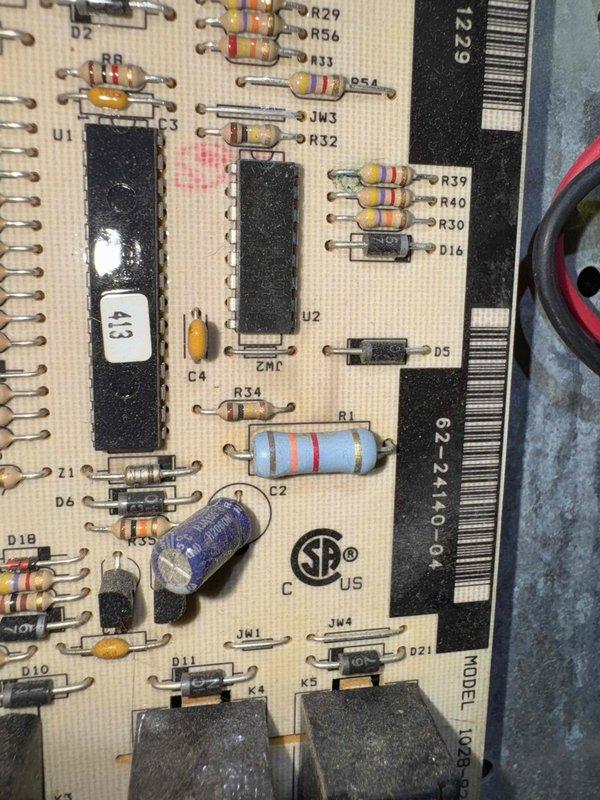 Responded to no heat call and performed diagnostic testing on furnace system. Upon inspection, utilized digital manometer to measure pressure readings within the HVAC unit, which indicated abnormal values. Further investigation revealed issues with the control board, where visual inspection showed a displaced blue electrolytic capacitor and potential component failure on the PCB. Diagnosed control board malfunction as the root cause of heating system failure and documented findings with diagnostic measurements and circuit board condition for repair recommendations.