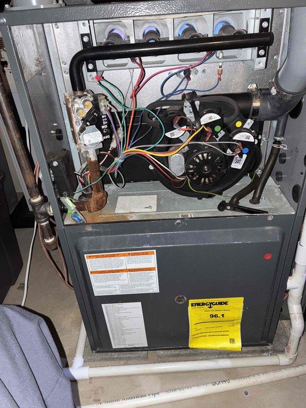 # HVAC Heating Maintenance Service

Completed comprehensive heating system maintenance on residential high-efficiency furnace unit (96.1% AFUE rating). Performed thorough inspection of all internal components including blower motor assembly, gas manifold connections, ignition system, and electrical connections. Verified proper operation of all safety controls, capacitors, and relays. Inspected gas line fittings and connections, noting surface oxidation on brass fittings consistent with normal operation. Examined furnace heat exchanger, burner assembly, and flue pipe for proper condition and secure mounting. Tested all electrical connections including multi-colored control wiring to ensure secure terminations. Verified blower motor operation and mounting integrity. Confirmed all manufacturer labels and safety warnings remain legible and properly affixed. System demonstrated normal operational parameters and is ready for heating season.