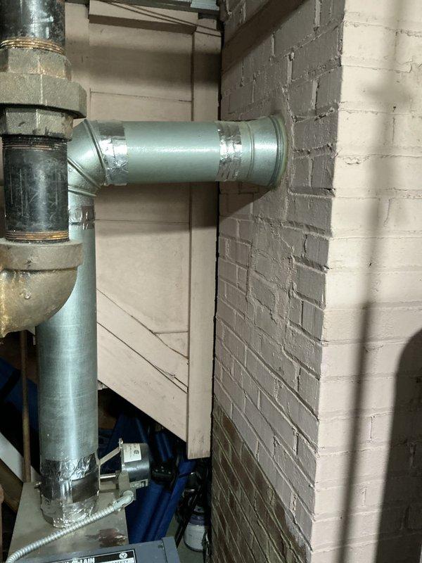 Conducted comprehensive inspection of Weil-McLain boiler system in basement following reports of visible corrosion and concerns about potential replacement needs. Assessed boiler unit of unknown age, examining all accessible components including the heat exchanger, piping connections, and control systems. Evaluated existing piping infrastructure, noting combination of older weathered piping showing signs of age and corrosion alongside newer ductwork installations. Inspected all pipe joints, connections, and valve assemblies for integrity and potential leak points. Documented condition of boiler casing, internal components where accessible, and surrounding mechanical systems. Photographed equipment and piping configuration to support estimate preparation for repair versus replacement options, providing detailed assessment of system condition and recommendations for next steps.
