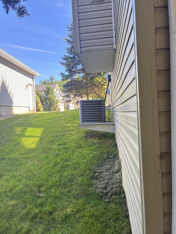 Conducted comprehensive assessment of residential HVAC system for complete replacement estimate following maintenance cost concerns with existing furnace and air conditioning equipment. Evaluated outdoor condensing unit positioned along exterior wall and inspected interior mechanical components including ductwork, PVC drainage system, and flexible conduit connections. Documented existing system configuration and infrastructure to provide accurate replacement recommendations for complete heating and cooling system upgrade.