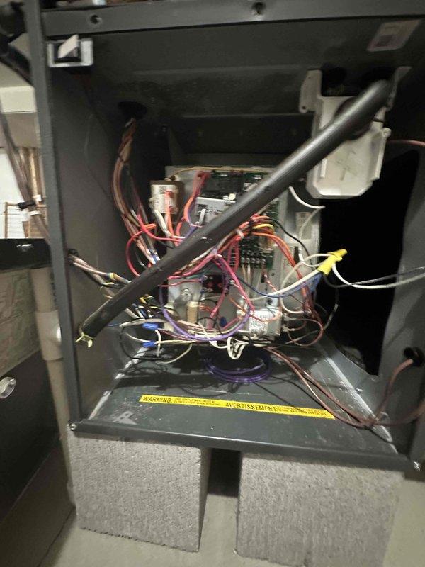 Completed comprehensive heating maintenance on furnace system as part of ongoing preventive maintenance program. Performed thorough inspection of furnace interior compartment, examining all electrical connections, wiring harnesses, and control components for proper operation and safety compliance. Verified electrical amperage draws using clamp meter to ensure system is operating within manufacturer specifications. Inspected all wire terminations including brown, red, blue, purple, white, and yellow control wiring for secure connections and proper routing. Checked condition of insulated refrigerant lines and verified all safety warning labels remain legible and intact. All components found operating normally with no deficiencies noted. System ready for heating season operation.