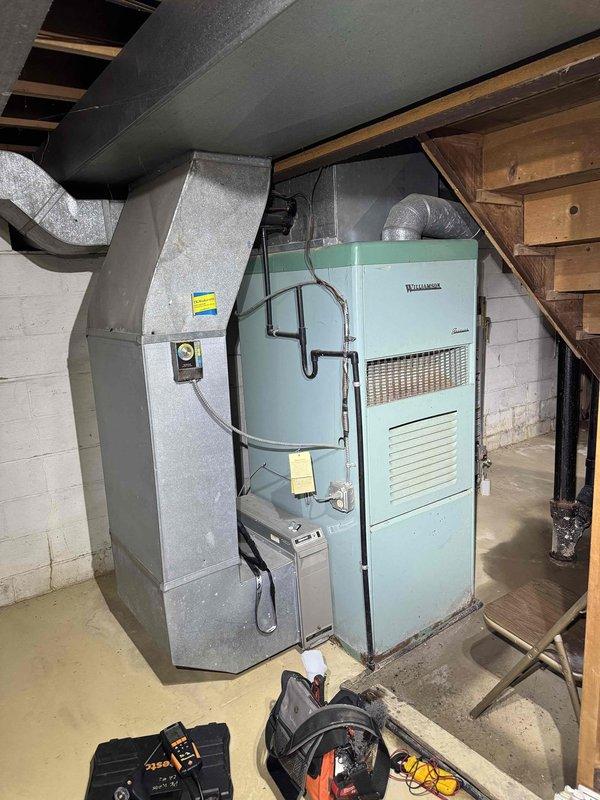 Performed comprehensive tune-up and diagnostic evaluation on 40-year-old Williamson furnace in basement after customer reported unit was not shutting off properly. Conducted combustion analysis using Testo 310 analyzer, recording temperature readings of 96° and 75.8° to assess system efficiency and safety parameters. Inspected all mechanical components, ductwork connections, and control systems to identify cause of thermostat cycling issue and verified proper operation of all safety controls and limit switches.
