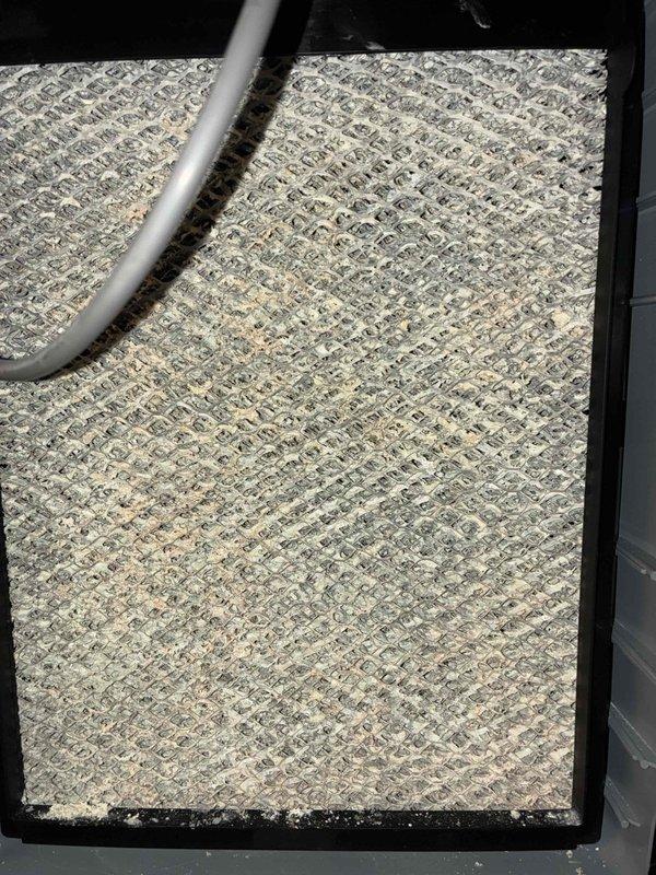 # HVAC Heating Maintenance Completed

Performed comprehensive heating system maintenance on residential HVAC unit. Conducted thorough inspection of air filtration system, identifying moderate dust and debris accumulation on pleated air filter within black metal housing unit. Filter showed typical wear patterns consistent with normal operation period but remained structurally intact and functional. Documented filter condition with photographic evidence showing diagonal cross-hatch pattern and beige coloration with visible particulate buildup.

Performed diagnostic measurements using calibrated digital testing equipment to verify system performance parameters. Tested airflow and temperature readings at supply register to ensure proper heating system operation and adequate air distribution throughout the space. All measurements recorded and verified against manufacturer specifications to confirm system operating within normal parameters.

System components inspected and found to be in sat