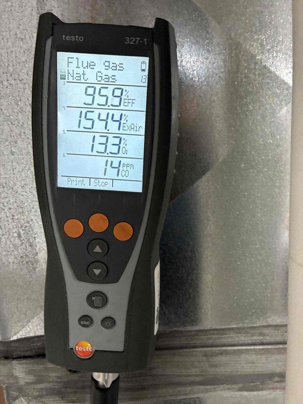 Completed heating maintenance tune-up on residential HVAC system. Performed combustion analysis using digital flue gas analyzer, confirming efficient operation with readings of 95.9% efficiency, 154.4°F exhaust temperature, and safe 14 PPM carbon monoxide levels. Inspected blower assembly and documented moderate dust accumulation on squirrel-cage fan wheel; system operating within normal parameters.