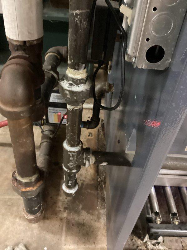 Completed annual maintenance tune-up on residential boiler system located in basement. Performed comprehensive inspection of all components including burner assembly, heat exchanger, piping connections, and safety controls. Verified proper operation of all system functions, cleaned burner surfaces, and tested combustion efficiency. Inspected associated plumbing infrastructure and documented areas showing signs of aging and corrosion on copper supply lines and water-damaged floor joists above equipment. All safety devices tested and confirmed operational. System running properly at time of service completion.