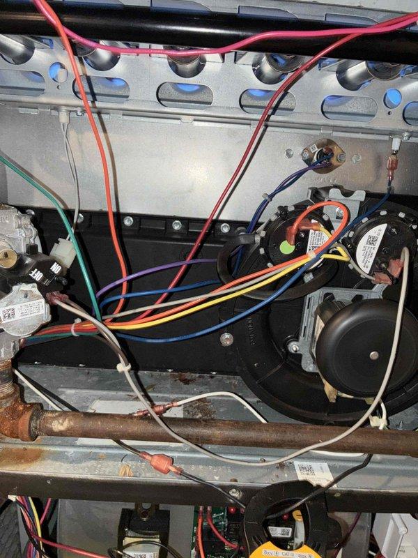 # HVAC Heating Maintenance Summary

Completed comprehensive heating maintenance service on residential furnace system as part of scheduled preventive maintenance program. Performed thorough inspection of all furnace components including heat exchanger, blower motor assembly, gas valve, and burner system.

# Detailed Work Performed

Conducted electrical diagnostics using digital multimeter to verify proper voltage and amperage readings across control circuits and safety devices. Measured microamp readings on flame sensor circuit, recording 0.053 and 0.121 values to confirm adequate flame rectification for safe ignition and operation. Verified all electrical connections were secure throughout the control board, transformer, and wiring harnesses.

Inspected blower motor assembly and confirmed proper operation. Checked all wire connections including thermostat wiring (R, C, W, G, Y terminals) and verified color-coded wiring was properly terminated at control board and components. Examined 