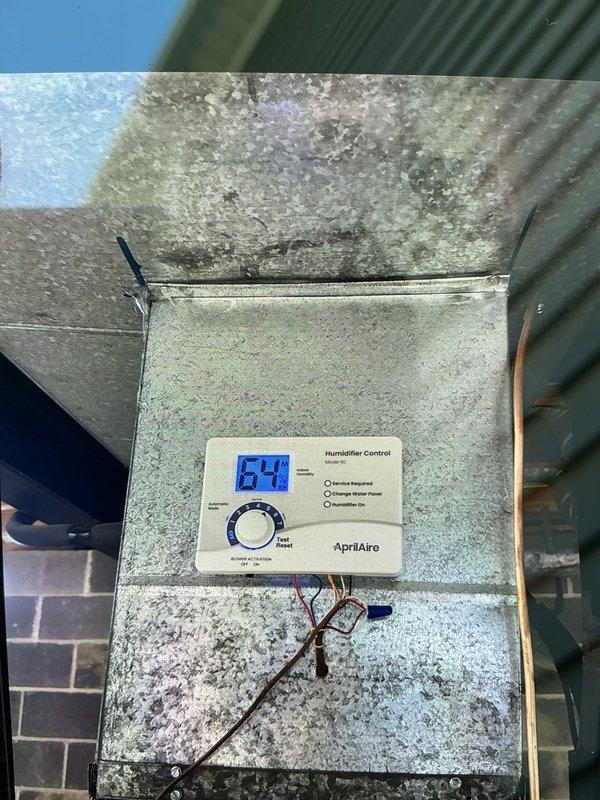 # HVAC Cooling Maintenance Summary
Completed scheduled preventive maintenance service on residential Amana air conditioning system. Performed comprehensive inspection of outdoor condenser unit, which was found to be in good operational condition with clean exterior surfaces and proper placement on concrete pad. Inspected AprilAire Model 62 humidifier control unit mounted within air handler, noting significant mineral deposits and water staining on interior metal surfaces indicative of long-term moisture exposure. Verified humidifier control functionality with digital display reading 64. System components operational at time of service completion. # HVAC Cooling Maintenance Summary
Completed scheduled preventive maintenance service on residential Amana air conditioning system. Performed comprehensive inspection of outdoor condenser unit, which was found to be in good operational condition with clean exterior surfaces and proper placement on concrete pad. Inspected AprilAire Model 62 humidifier control unit mounted within air handler, noting significant mineral deposits and water staining on interior metal surfaces indicative of long-term moisture exposure. Verified humidifier control functionality with digital display reading 64. System components operational at time of service completion.
