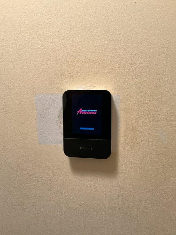 Responded to service call for thermostat communication failure with furnace system. Upon arrival, verified that the Amana wall-mounted digital thermostat was not establishing proper communication with the heating unit. Diagnosed the issue, restored connectivity between the thermostat and furnace control board, and confirmed proper system operation with temperature display functioning correctly at 77°F on both the physical thermostat and connected mobile application. Responded to service call for thermostat communication failure with furnace system. Upon arrival, verified that the Amana wall-mounted digital thermostat was not establishing proper communication with the heating unit. Diagnosed the issue, restored connectivity between the thermostat and furnace control board, and confirmed proper system operation with temperature display functioning correctly at 77°F on both the physical thermostat and connected mobile application.