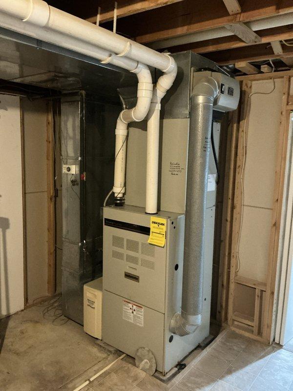 Conducted on-site evaluation of 25-year-old residential furnace system located in unfinished basement area. Assessed current equipment condition, documented existing installation including ductwork configuration, PVC venting system, and electrical connections. Provided replacement furnace options and recommendations based on system age and operational status.