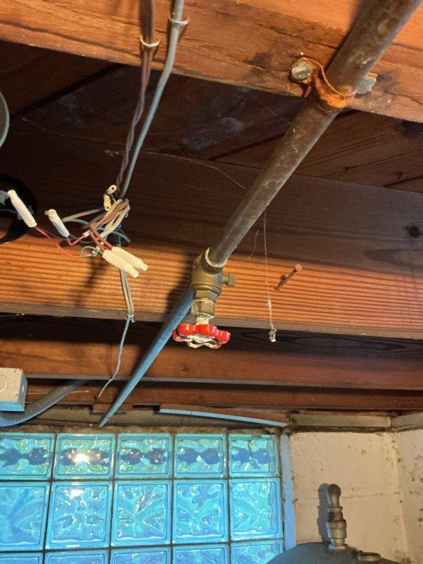 Performed routine maintenance flush on tanked water heater system located in garage utility area. Drained sediment buildup from tank bottom through drain valve to improve heating efficiency and extend equipment lifespan. Verified proper valve operation and confirmed all plumbing connections remained secure throughout the procedure.