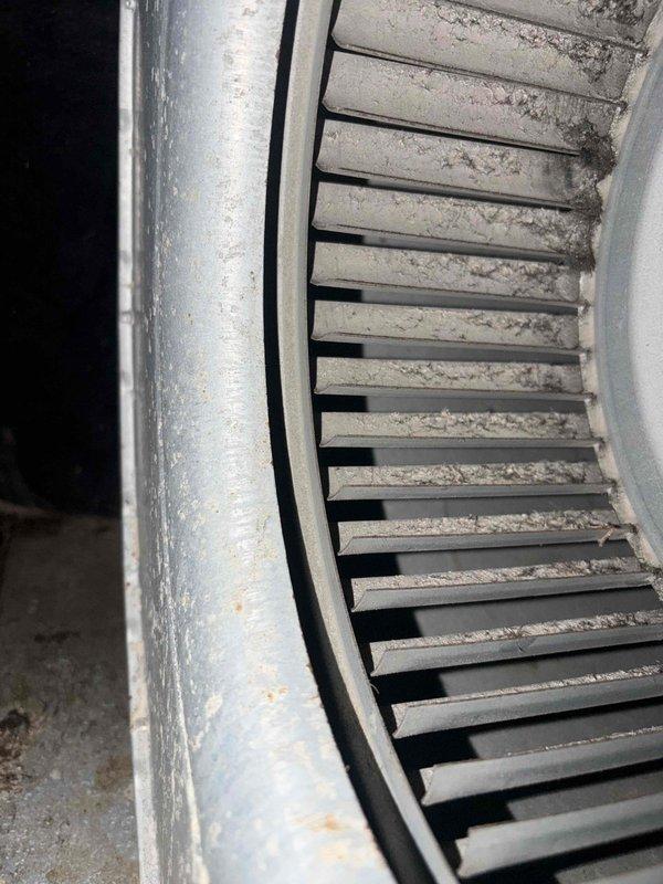 # HVAC Heating Maintenance Completed

Performed comprehensive heating maintenance on a Carrier gas furnace system as part of routine preventive maintenance service. Upon inspection, discovered significant dust and debris accumulation on the blower wheel assembly, with thick grayish buildup covering the blades that indicated extended operation without cleaning. Thoroughly cleaned the blower wheel and housing to restore optimal airflow efficiency and prevent reduced heating performance.

Inspected all internal mechanical and electrical components including the blower motor, wiring connections, and ductwork assembly. Verified proper operation of the motor windings and circular blower fan. Checked all electrical connections including red, white, and green wires for secure attachment and proper termination. Examined furnace cabinet, metal framework, and galvanized duct pipe for structural integrity and proper installation. All manufacturer labels, safety warnings, and technical specificatio