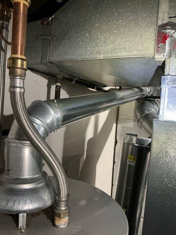 Performed routine maintenance flush on tanked water heater in 11-year-old residential property. Drained sediment buildup from tank, inspected pressure relief valve, brass fittings, and copper supply lines for proper operation and signs of corrosion, then refilled unit and verified all connections for leaks.