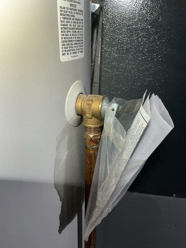 Performed routine maintenance flush on tanked water heater in 11-year-old residential property. Drained sediment buildup from tank, inspected pressure relief valve, brass fittings, and copper supply lines for proper operation and signs of corrosion, then refilled unit and verified all connections for leaks.