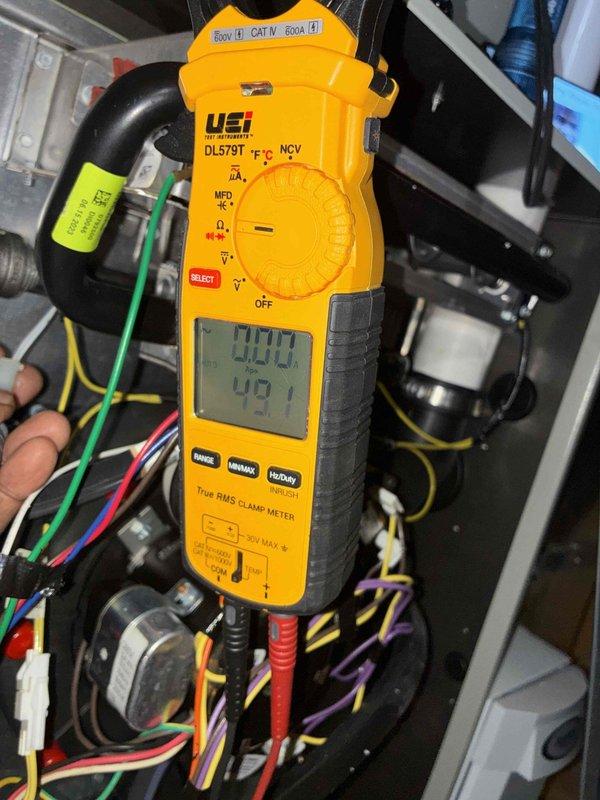 Completed comprehensive heating tune-up on HVAC system, including internal component inspection of blower assembly, heat exchanger tubes, and electrical connections. Performed diagnostic testing using digital clamp meter to verify proper electrical readings and system operation, with all components found functioning within normal parameters.