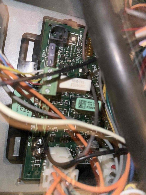 # HVAC Cooling System Maintenance

Completed comprehensive preventive maintenance service on residential cooling system as part of ongoing maintenance program. Performed thorough inspection of all major components including evaporator coil, blower motor assembly, and electronic control boards. 

Inspected control panel housing containing multiple circuit boards with electronic controls, verified proper connections on all multi-colored wiring harnesses and white plastic connectors. Confirmed 3A fuse rating and examined all electronic components including microchips, resistors, and capacitors for proper operation. Checked all gold-colored pin connectors along circuit board edges for secure contact.

Examined blower motor unit and associated electrical connections, verifying proper wire terminations on multi-terminal connector block with blue, white, red, and pink wiring. Inspected motor housing, mounting brackets, and surrounding black plastic ductwork assembly for secure installation an