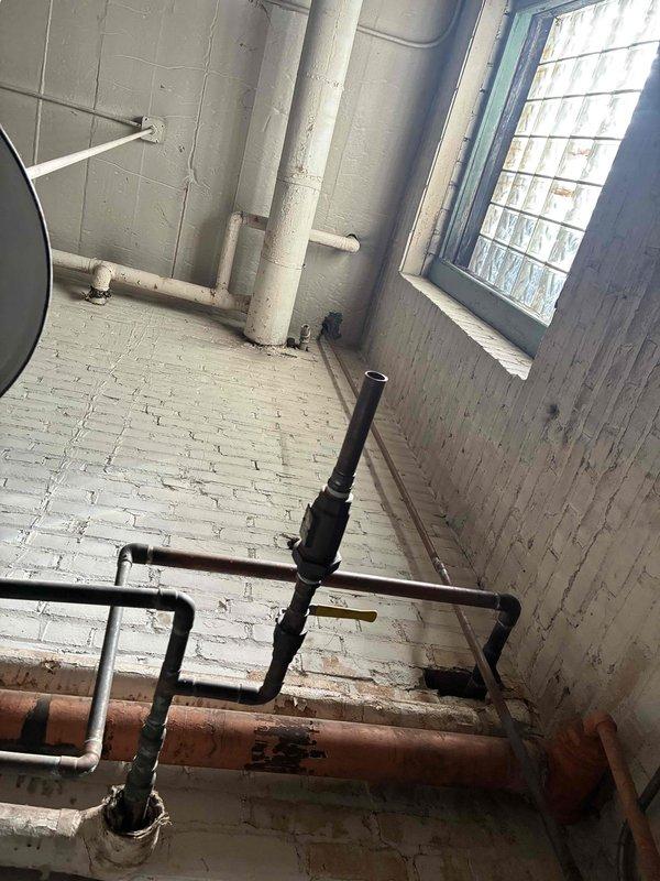 Completed commercial boiler installation over five-day period, including removal of existing aged boiler system with oxidized copper piping, pressure regulators, and associated plumbing components. Installed new boiler system with updated piping configuration, ensuring proper integration with existing HVAC ductwork and building infrastructure in utility room with glass block windows and brick construction. Completed commercial boiler installation over five-day period, including removal of existing aged boiler system with oxidized copper piping, pressure regulators, and associated plumbing components. Installed new boiler system with updated piping configuration, ensuring proper integration with existing HVAC ductwork and building infrastructure in utility room with glass block windows and brick construction.