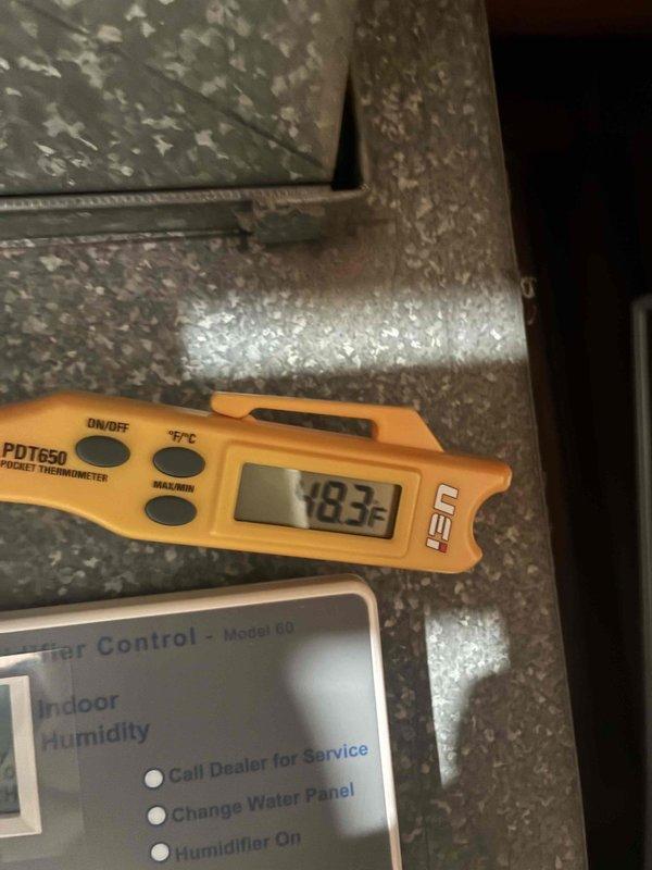 Completed comprehensive cooling system maintenance on HVAC unit. Inspected evaporator coil and filter assembly, which showed moderate dust accumulation in upper section requiring attention. Verified system operation with supply air temperature reading of 18.3°F, confirming proper refrigerant charge and cooling performance. Checked refrigerant line connections and humidifier control panel for proper operation.