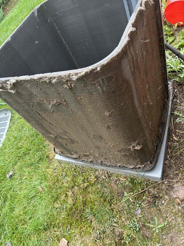Performed comprehensive coil cleaning service on outdoor condensing unit that exhibited heavy accumulation of dirt, mud, and debris on exterior surfaces and heat exchanger fins. Thoroughly cleaned and restored unit to proper operating condition, removing significant buildup that had accumulated on metal casing, fins, and protective panels to ensure optimal airflow and system efficiency. Performed comprehensive coil cleaning service on outdoor condensing unit that exhibited heavy accumulation of dirt, mud, and debris on exterior surfaces and heat exchanger fins. Thoroughly cleaned and restored unit to proper operating condition, removing significant buildup that had accumulated on metal casing, fins, and protective panels to ensure optimal airflow and system efficiency.