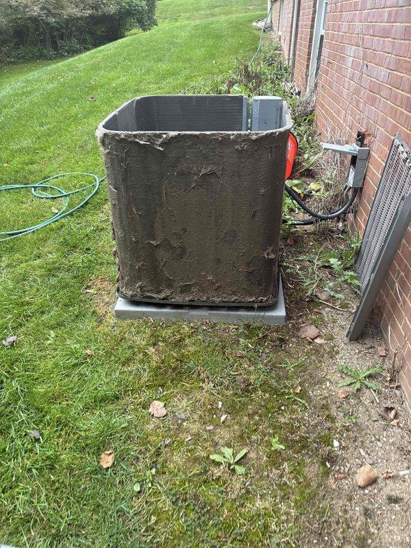 Performed comprehensive coil cleaning service on outdoor condensing unit that exhibited heavy accumulation of dirt, mud, and debris on exterior surfaces and heat exchanger fins. Thoroughly cleaned and restored unit to proper operating condition, removing significant buildup that had accumulated on metal casing, fins, and protective panels to ensure optimal airflow and system efficiency. Performed comprehensive coil cleaning service on outdoor condensing unit that exhibited heavy accumulation of dirt, mud, and debris on exterior surfaces and heat exchanger fins. Thoroughly cleaned and restored unit to proper operating condition, removing significant buildup that had accumulated on metal casing, fins, and protective panels to ensure optimal airflow and system efficiency.