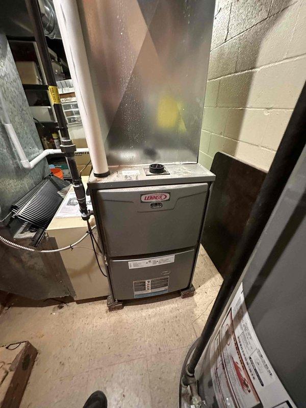 Completed scheduled heating maintenance on residential Lennox furnace system located in basement mechanical room. Performed comprehensive inspection of furnace unit, verified proper operation of all components, and documented system condition through photographic records. Inspected associated water heater and plumbing connections, noting proper installation of dielectric union and copper piping configuration. All equipment found to be in satisfactory operating condition with no immediate service needs identified.