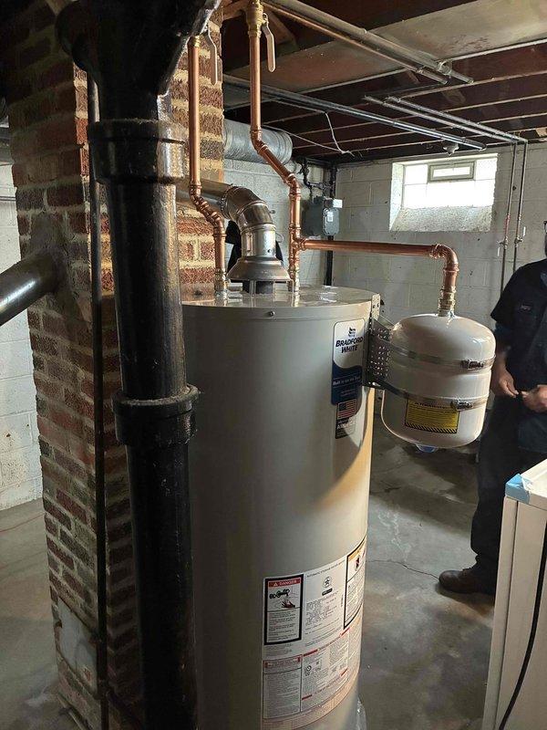 Replaced a 50-gallon tall hot water heater in the basement utility room. The installation included connecting new copper supply lines, installing an expansion tank, and ensuring proper venting through the existing flue system. All plumbing connections were completed to code with brass fittings and shut-off valves for future serviceability. Replaced a 50-gallon tall hot water heater in the basement utility room. The installation included connecting new copper supply lines, installing an expansion tank, and ensuring proper venting through the existing flue system. All plumbing connections were completed to code with brass fittings and shut-off valves for future serviceability.