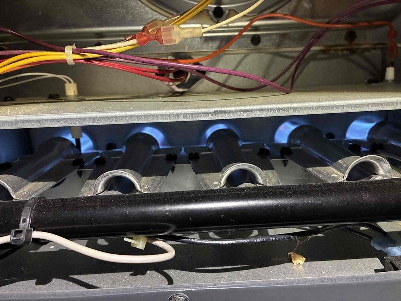 Completed scheduled heating maintenance on residential gas furnace system. Performed comprehensive inspection of burner assembly, heat exchanger, and ignition components. Verified proper flame characteristics with all burners operating correctly and producing appropriate blue flame pattern. Inspected gas manifold, burner tubes, and associated electrical connections including flame sensor and ignition wiring. All control wiring connections were secure with proper wire management in place. System tested during operation and confirmed proper heating cycle functionality with no issues detected.