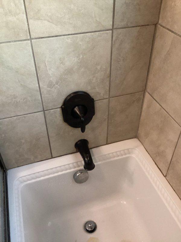 Kirtland, OH - Returned to site for shower repair completion. Inspected black tub spout and control valve assembly on beige ceramic tile surround. Service on hold pending customer receipt of replacement part; awaiting callback to schedule final installation and testing. Kirtland, OH - Returned to site for shower repair completion. Inspected black tub spout and control valve assembly on beige ceramic tile surround. Service on hold pending customer receipt of replacement part; awaiting callback to schedule final installation and testing.