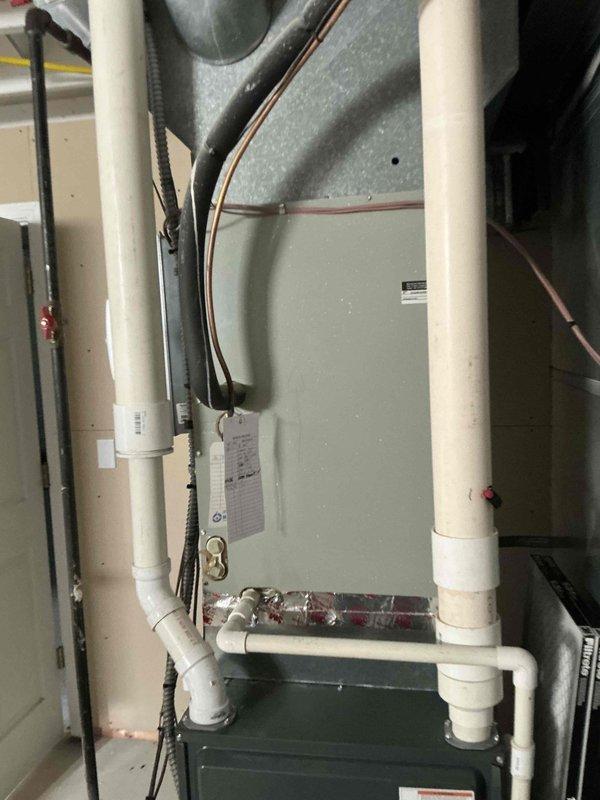 Conducted on-site evaluation of existing HVAC system and documented current equipment configuration including air handler unit, ductwork, and associated refrigerant and condensate lines. Photographed equipment specifications, manufacturer labels, and installation layout to provide comprehensive replacement options for the aging system.
