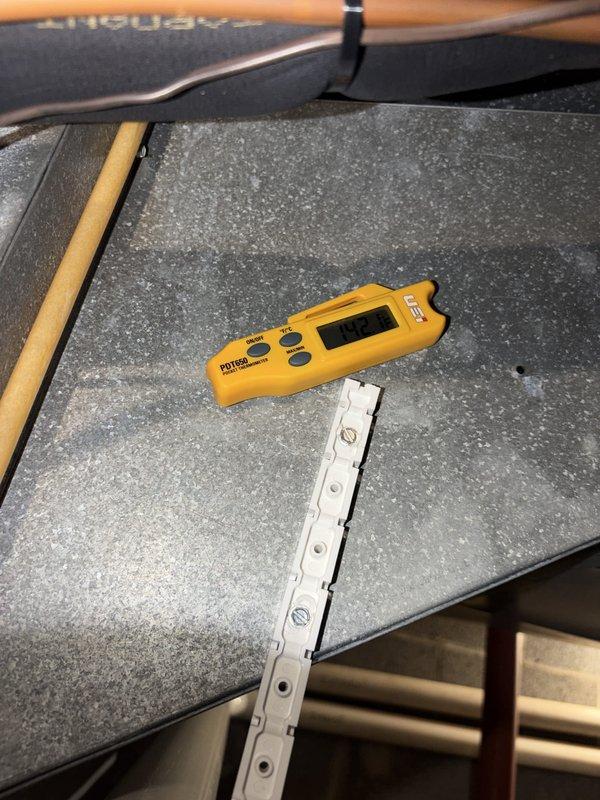 Completed comprehensive heating system maintenance on aging HVAC unit. Performed thorough inspection of blower assembly, noting accumulated dust and debris on squirrel cage fan blades and components. Conducted diagnostic measurements using digital testing equipment to verify system performance and operational parameters.
