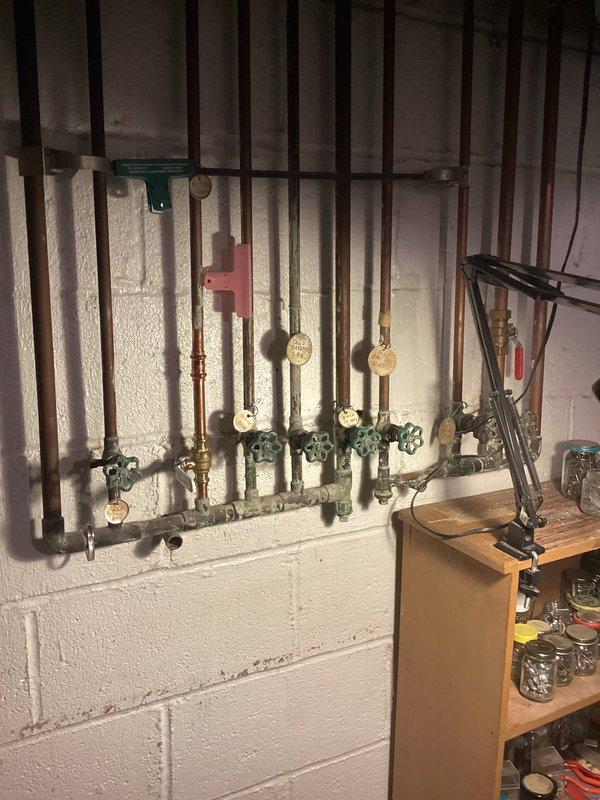 Completed comprehensive plumbing inspection of utility room and identified multiple shut-off valves requiring replacement due to age and wear. Replaced deficient shut-off valves on copper pipe manifold system, ensuring proper operation and leak-free connections. All valves tested for functionality and system verified operational upon completion.