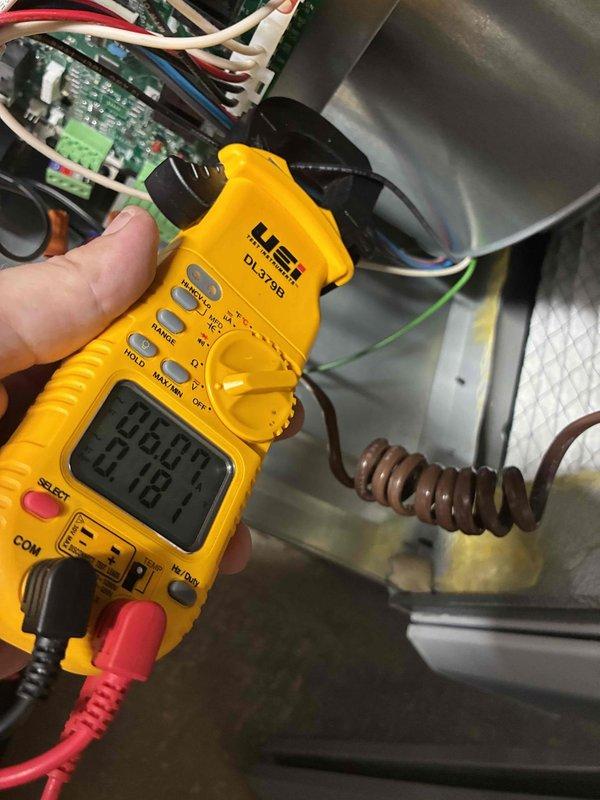 # HVAC Heating Maintenance Service
Completed comprehensive heating system maintenance on residential furnace unit. Performed thorough inspection of air handler assembly, including examination of air filter condition and housing integrity. Filter showed proper installation within black frame assembly with all mounting hardware secure. Verified condensate collection pan condition and drainage pathway, noting normal operational moisture levels.
Conducted detailed electrical diagnostics using digital multimeter to verify system voltage and control board functionality. Measured line voltage at 253.1 volts, confirming proper electrical supply to unit. Inspected control board for any signs of component failure or connection issues, with all wire terminals and connectors properly seated. Tested safety circuits and verified proper operation of all electrical connections including red, white, blue, and green control wiring.
Examined refrigerant line connections and brass fittings for any sign # HVAC Heating Maintenance Service
Completed comprehensive heating system maintenance on residential furnace unit. Performed thorough inspection of air handler assembly, including examination of air filter condition and housing integrity. Filter showed proper installation within black frame assembly with all mounting hardware secure. Verified condensate collection pan condition and drainage pathway, noting normal operational moisture levels.
Conducted detailed electrical diagnostics using digital multimeter to verify system voltage and control board functionality. Measured line voltage at 253.1 volts, confirming proper electrical supply to unit. Inspected control board for any signs of component failure or connection issues, with all wire terminals and connectors properly seated. Tested safety circuits and verified proper operation of all electrical connections including red, white, blue, and green control wiring.
Examined refrigerant line connections and brass fittings for any sign