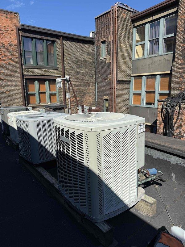 # HVAC Repair - Cooling System Efficiency Restoration

Responded to service call for significantly reduced cooling capacity on an 11-year-old air conditioning system. Upon arrival, performed comprehensive diagnostic evaluation of both indoor air handler unit located in utility room and outdoor condenser units positioned on rooftop. 

Conducted visual inspection of mechanical equipment, ductwork, and refrigerant line connections. Assessed airflow patterns through supply ductwork system and verified proper operation of air handler components. Examined outdoor condenser units for operational efficiency, checking louvered panels for adequate air circulation and inspecting copper refrigerant lines running along exterior wall for proper insulation and connections.

Identified efficiency issues affecting overall system performance. Performed necessary adjustments and repairs to restore cooling capacity to manufacturer specifications. Verified proper refrigerant pressures and system operation 