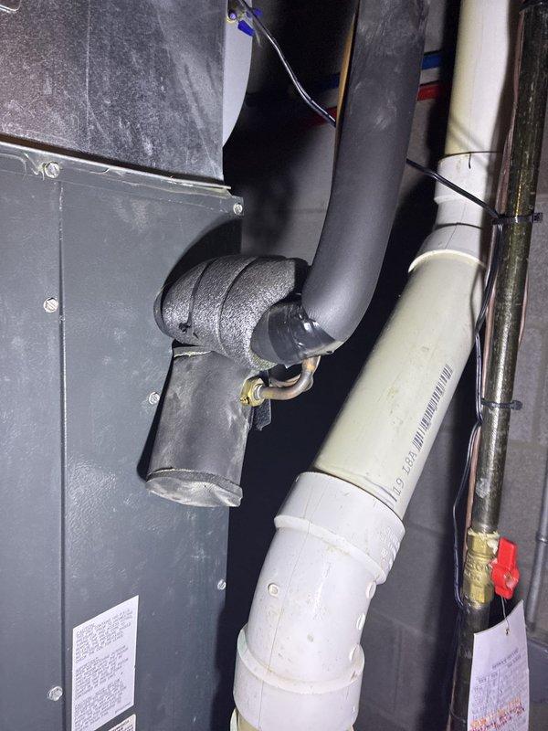 Conducted comprehensive HVAC system evaluation for full replacement estimate at residential property accessed via garage entry. Documented existing gas furnace installation showing heat exchanger, blower motor assembly, gas valve components, and associated electrical wiring harnesses. Photographed current system configuration including ductwork connections, PVC condensate drainage, refrigerant line sets with foam insulation, and mechanical room layout to provide homeowner with complete system replacement options and equipment specifications.