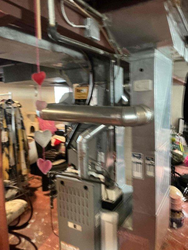 Conducted on-site assessment of existing residential HVAC system to provide furnace replacement options. Documented current furnace unit, ductwork configuration including rigid and flexible metallic components, and overall system layout in basement utility area for equipment upgrade evaluation.