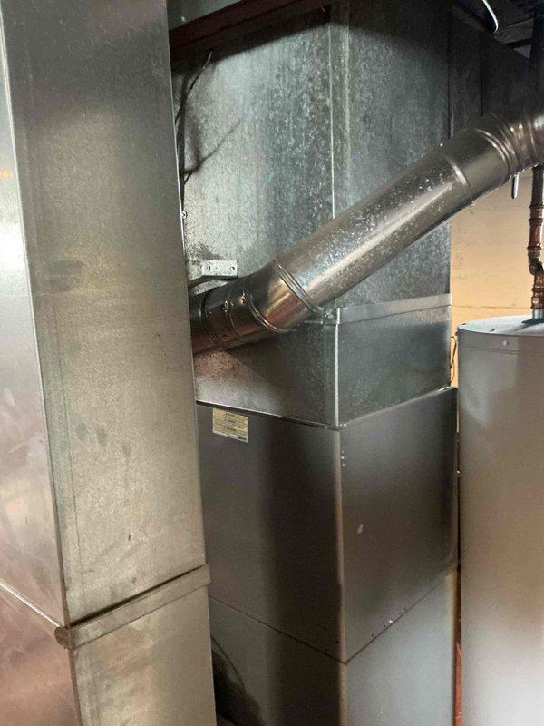 Conducted on-site assessment of existing residential HVAC system to provide furnace replacement options. Documented current furnace unit, ductwork configuration including rigid and flexible metallic components, and overall system layout in basement utility area for equipment upgrade evaluation.