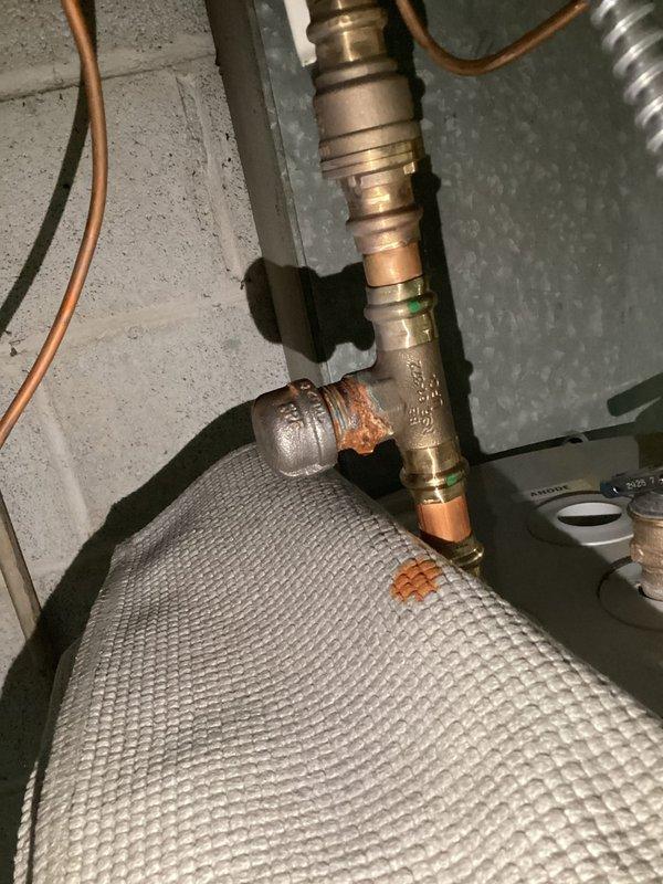 Responded to a water heater leak in the afternoon. Upon inspection, identified active leaking from corroded copper pipe fittings and connections in the water heater assembly. The copper piping showed significant oxidation and rust-colored mineral deposits at multiple connection points, indicating deterioration of the fittings. Documented the condition of the plumbing system, including the water pressure regulator, copper supply lines, and water heater connections for repair recommendations. Responded to a water heater leak in the afternoon. Upon inspection, identified active leaking from corroded copper pipe fittings and connections in the water heater assembly. The copper piping showed significant oxidation and rust-colored mineral deposits at multiple connection points, indicating deterioration of the fittings. Documented the condition of the plumbing system, including the water pressure regulator, copper supply lines, and water heater connections for repair recommendations.
