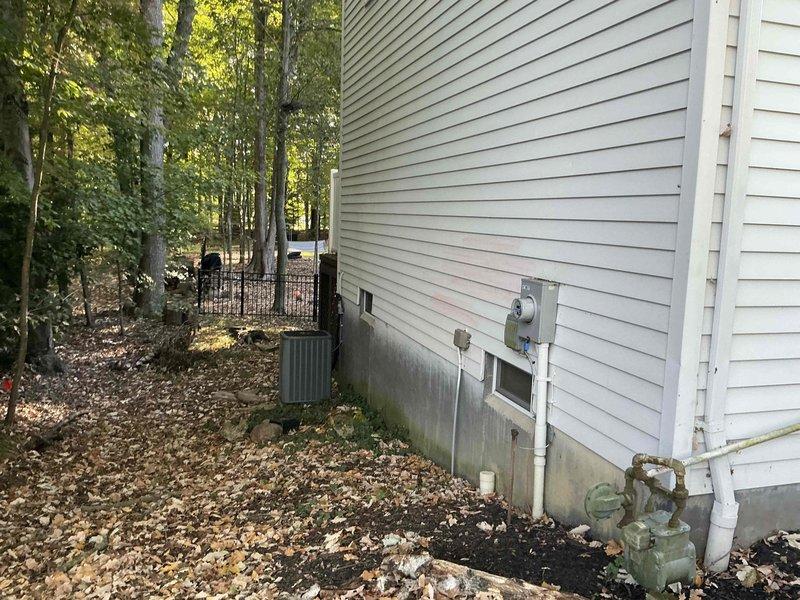 Completed full HVAC system replacement estimate at residential property with easy access conditions. Installation site evaluated for outdoor condenser unit and air handler placement on existing concrete pad at side of building, with electrical disconnect and conduit routing assessed. Property features suitable foundation clearance and adequate space for complete furnace and air conditioning system replacement with straightforward access for equipment installation.