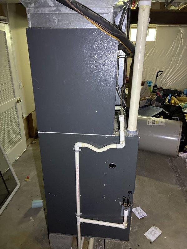 Completed comprehensive HVAC system replacement estimate for hail-damaged equipment. Documented existing furnace installation in basement utility area, including dark gray cabinet-style unit with white PVC venting system and refrigerant line connections. Assessed current equipment condition and photographed all components for insurance claim documentation, capturing furnace cabinet, condensate management system, copper refrigerant lines, flexible ductwork connections, and air handler compartment details to support full system replacement proposal. Completed comprehensive HVAC system replacement estimate for hail-damaged equipment. Documented existing furnace installation in basement utility area, including dark gray cabinet-style unit with white PVC venting system and refrigerant line connections. Assessed current equipment condition and photographed all components for insurance claim documentation, capturing furnace cabinet, condensate management system, copper refrigerant lines, flexible ductwork connections, and air handler compartment details to support full system replacement proposal.