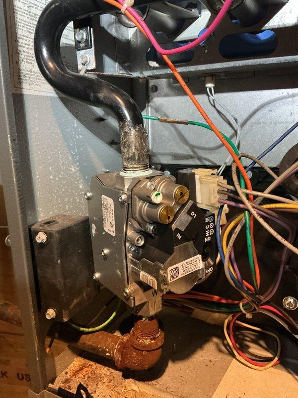 Responded to second service call to replace defective gas valve on heating unit. Removed access panel to electrical and mechanical compartment, disconnected multiple wire connections from failed gas valve assembly, and isolated gas supply. Installed new gas valve with proper electrical terminations including all control and safety circuit wiring. Verified all connections were secure, restored gas supply, and performed operational testing to confirm proper ignition sequence and flame sensing. Unit cycling normally with all safety controls functioning as designed.