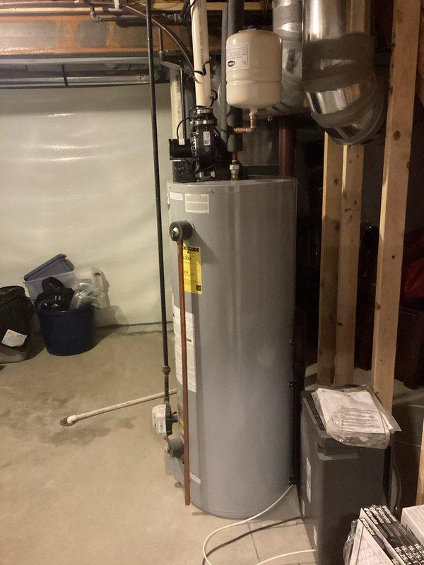 Completed comprehensive plumbing inspection of residential basement utility area. Documented existing sump pump drainage system with vertical PVC discharge line and inspected water heater installation including expansion tank, supply lines, and associated mechanical connections. All systems photographed for record-keeping purposes. Completed comprehensive plumbing inspection of residential basement utility area. Documented existing sump pump drainage system with vertical PVC discharge line and inspected water heater installation including expansion tank, supply lines, and associated mechanical connections. All systems photographed for record-keeping purposes.