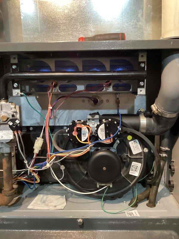 Returned to complete furnace repair by replacing faulty pressure switch. Removed access panel to access blower compartment and disconnected existing pressure switch from wiring harness and tubing connections. Installed new pressure switch, reconnected all electrical connections and pressure sensing tubes, and verified proper mounting. Tested system operation to confirm pressure switch functioning correctly and furnace cycling properly through all stages of operation.