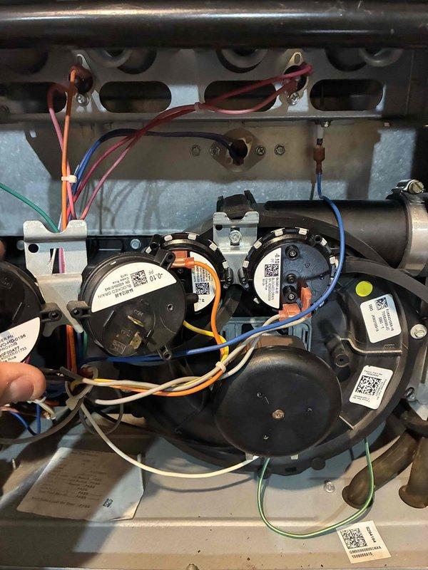 Returned to complete furnace repair by replacing faulty pressure switch. Removed access panel to access blower compartment and disconnected existing pressure switch from wiring harness and tubing connections. Installed new pressure switch, reconnected all electrical connections and pressure sensing tubes, and verified proper mounting. Tested system operation to confirm pressure switch functioning correctly and furnace cycling properly through all stages of operation.
