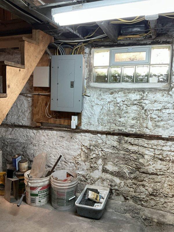 Conducted comprehensive site evaluation for Generac generator installation in residential basement utility area. Assessed existing gas meter infrastructure, electrical panel capacity, and available mounting locations. Documented current gas line configuration with black pipe connections and verified clearance requirements for generator placement. Evaluated electrical service panel conditions and determined integration points for automatic transfer switch installation. Photographed utility room layout including concrete block wall conditions, ceiling joist clearances, and workspace accessibility for equipment installation planning.