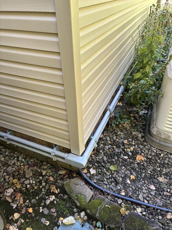 Conducted on-site evaluation to provide furnace replacement options for residential HVAC system. Documented existing exterior utility installations including heavily corroded condensate drainage components and deteriorating metal fittings requiring attention during equipment upgrade.