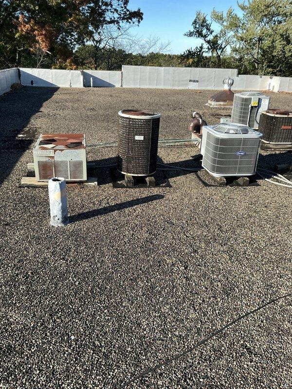 Conducted comprehensive rooftop assessment of existing 1984 Carrier air conditioning system for replacement estimate. The current RTU unit, located in an easily accessible rooftop position with gravel surface, has reached end of service life after over 40 years of operation. Documented existing equipment configuration including aged condenser unit showing significant weathering and oxidation, associated refrigerant lines, electrical conduit, and copper vent piping. Evaluated rooftop conditions, clearances, and existing mechanical infrastructure to determine optimal replacement specifications. Property utilizes boiler system for heating with pantry-mounted equipment. Provided detailed photographic documentation of current system condition and surrounding rooftop environment for replacement planning purposes.