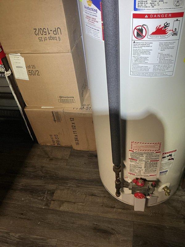 Responded to service call for reported boiler leak. Upon arrival, conducted thorough inspection of mechanical equipment and found the issue involved the water heater, not the boiler system. Documented existing installation showing 12-year warranty unit with copper piping connections, red-handled valves, and standard plumbing configuration. Photographed the equipment and surrounding plumbing connections to assess the source of the reported leak and provide visual documentation of current system condition. Responded to service call for reported boiler leak. Upon arrival, conducted thorough inspection of mechanical equipment and found the issue involved the water heater, not the boiler system. Documented existing installation showing 12-year warranty unit with copper piping connections, red-handled valves, and standard plumbing configuration. Photographed the equipment and surrounding plumbing connections to assess the source of the reported leak and provide visual documentation of current system condition.