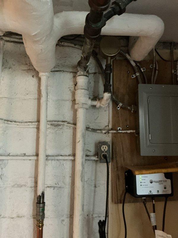 Conducted site evaluation for boiler replacement options in basement mechanical room. Assessed existing aged heating system with corroded black iron and galvanized steel piping showing significant wear and mineral deposits. Identified water line routing issue positioned above electrical panel that requires relocation to meet code compliance. Documented existing baseboard heating system infrastructure, including insulated PVC supply lines and electrical connections. Provided comprehensive replacement recommendations addressing both equipment upgrades and necessary piping modifications to ensure safe and compliant installation.