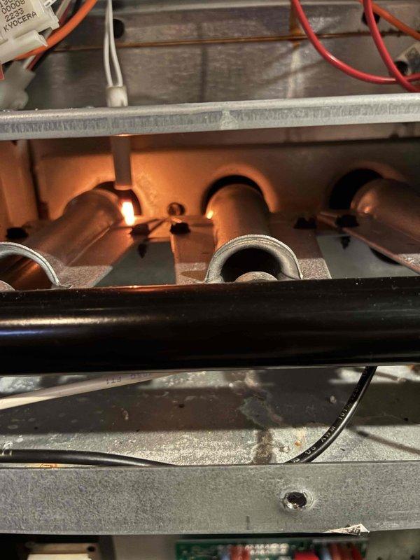 Completed scheduled preventive maintenance on Nortek furnace system as part of ongoing recurring service plan. Performed comprehensive heating system inspection, verified burner ignition and flame characteristics showing proper combustion with orange flame pattern visible through observation port, confirmed all electrical connections and control wiring secure at board terminals, and documented system operation through photographic records. All heating components found operating within normal parameters with no deficiencies requiring immediate attention.