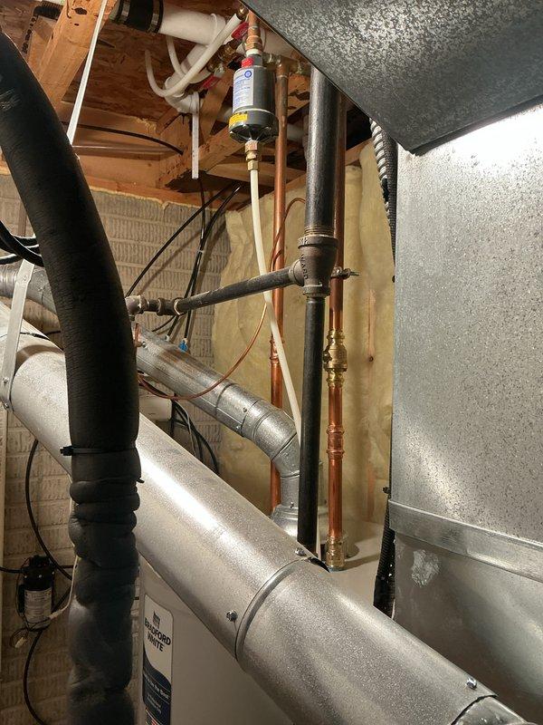 Completed comprehensive electrical inspection of residential utility space. Documented electrical panel installation showing dual-row circuit breaker configuration with main disconnect assembly and verified proper wire routing and color coding throughout the distribution system. Photographed mechanical room infrastructure including HVAC ductwork, plumbing integration, and electrical components to provide visual record of current installation status and system layout for future reference.