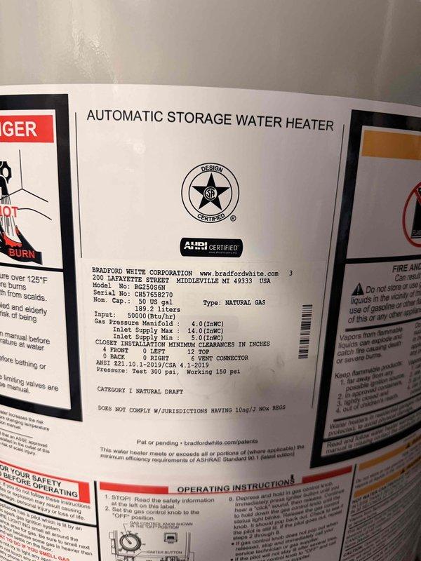 Completed installation of 50-gallon short Bradford White automatic storage natural gas water heater with expansion tank in basement utility room. Unit installed with proper copper piping connections, brass shutoff valves, code-compliant venting through masonry wall, and all safety labels visible per manufacturer specifications. Completed installation of 50-gallon short Bradford White automatic storage natural gas water heater with expansion tank in basement utility room. Unit installed with proper copper piping connections, brass shutoff valves, code-compliant venting through masonry wall, and all safety labels visible per manufacturer specifications.